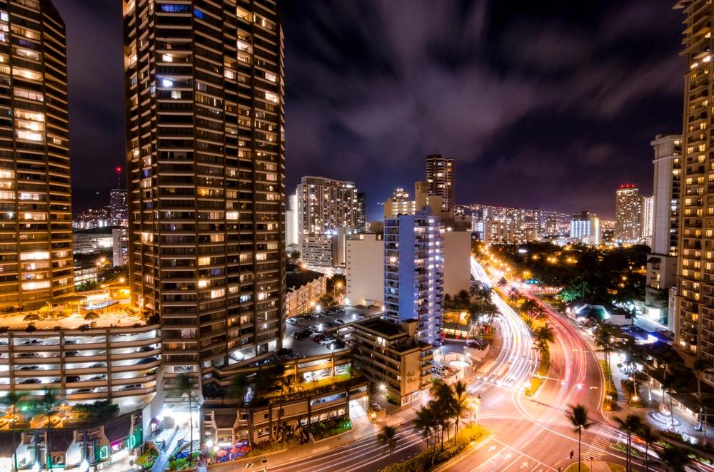 States Where Residents Are Spending the Most on Groceries - Infographics of Honolulu city lights at night, representing Hawaii—consistently among the top states with the highest grocery expenses.