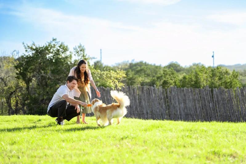 View of a couple enjoying their time outdoors with their dog.