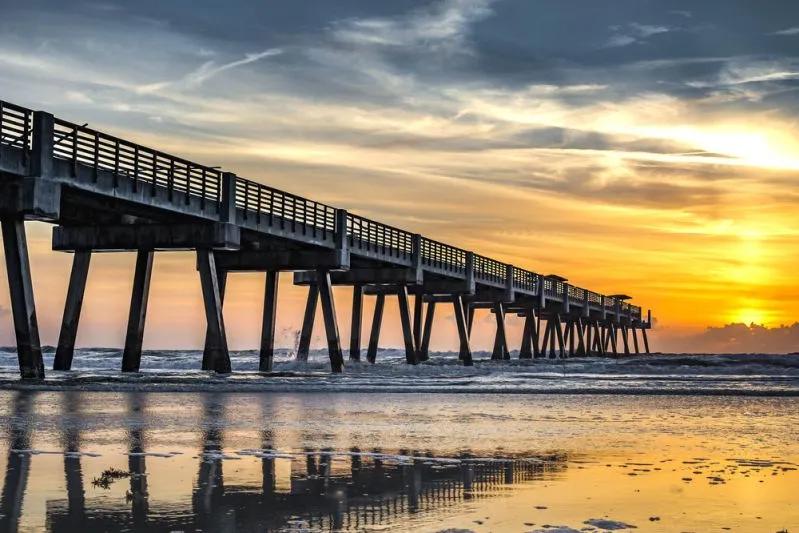 View of Tampa-area pier at sunrise symbolizing Florida’s steep Millennial renter wage gap in coastal cities.