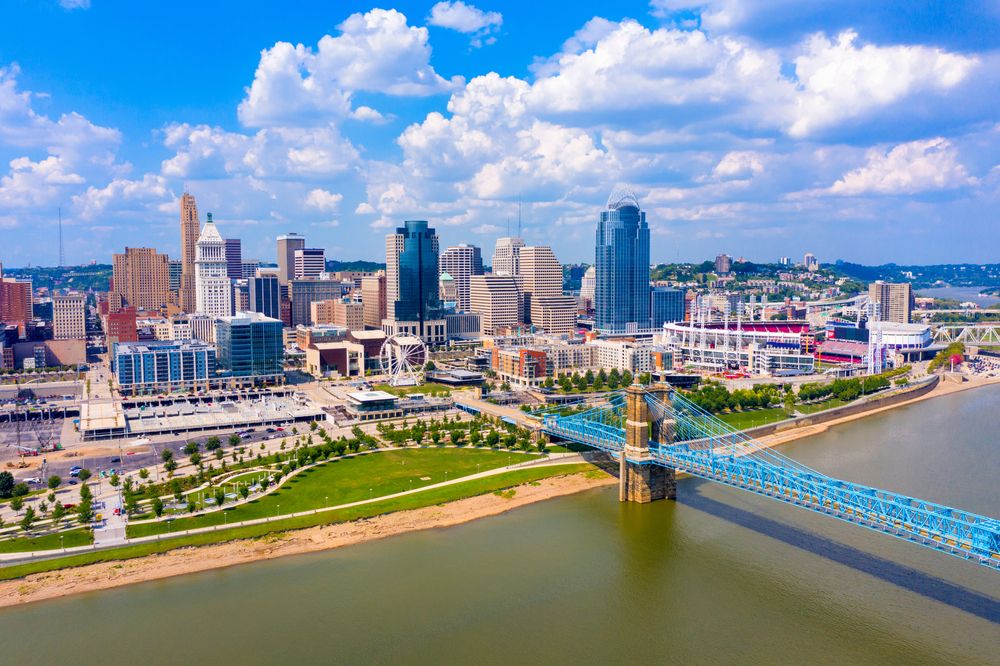 Downtown Cincinnati, Ohio skyline with John A. Roebling Suspension Bridge and riverfront view.