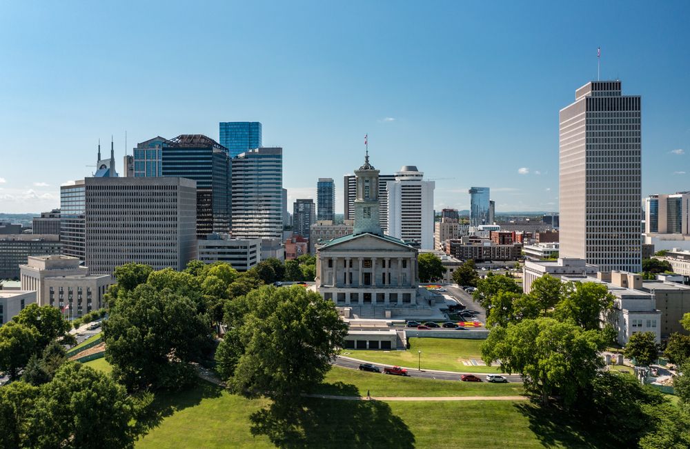 Aerial view of downtown Nashville with government buildings, skyscrapers, and green space