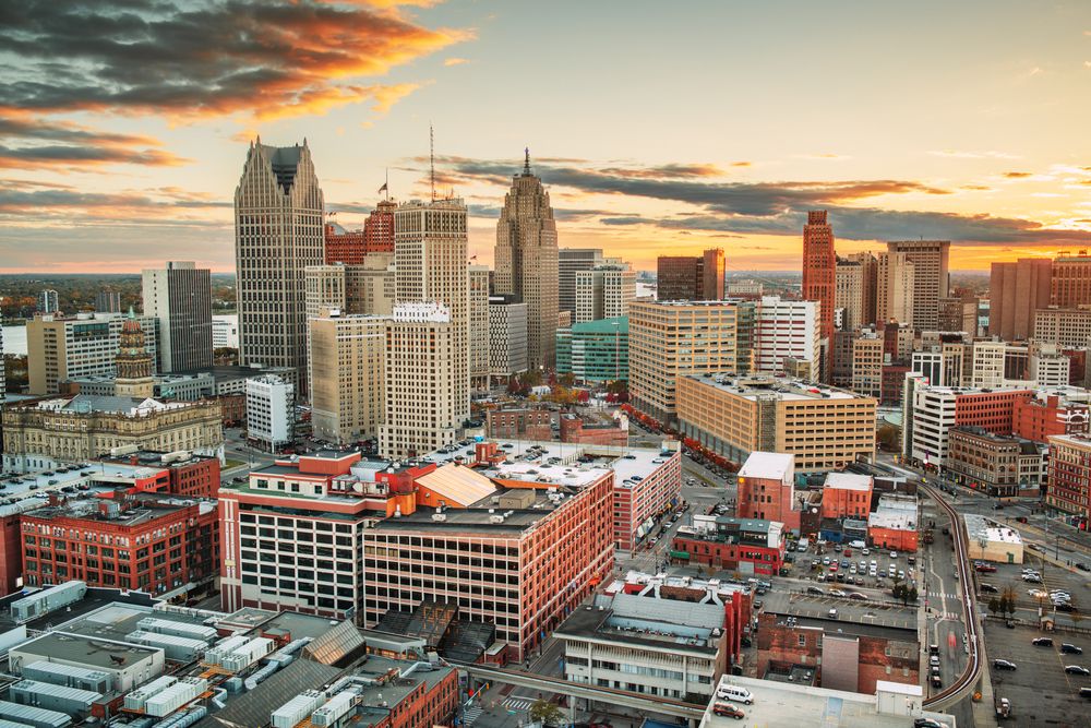Cities With the Most Residents Who Smoke -Infographics of Skyline view of Detroit, Michigan at sunset, a city known for high smoking rates among residents.