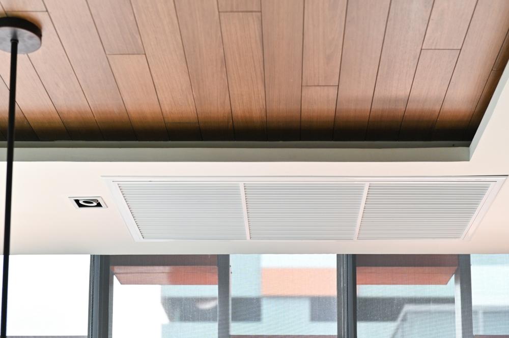  View of a ceiling air vent in a modern home.