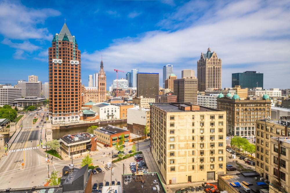 View of downtown Atlanta skyline featuring high-rise buildings under a bright blue sky.