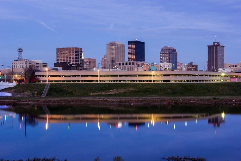 The Hottest City in Every State - Infographics of twilight reflecting on the river in Dayton, Ohio Buckeye State’s hottest city, where summer humidity amplifies the urban heat.