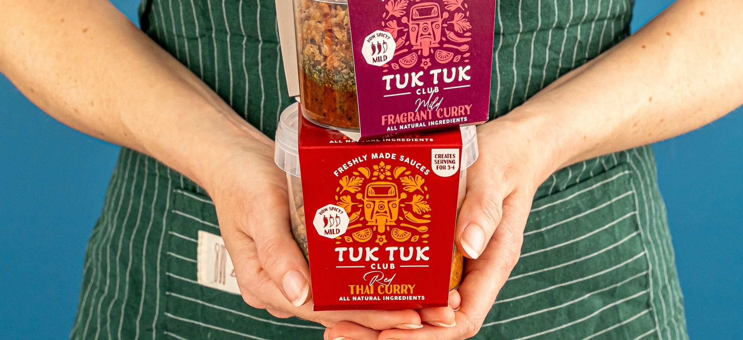 Stack of Tuk Tuk Club sauces held in someones hands