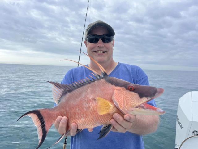 Captain David White Fishing Charters client with their catch