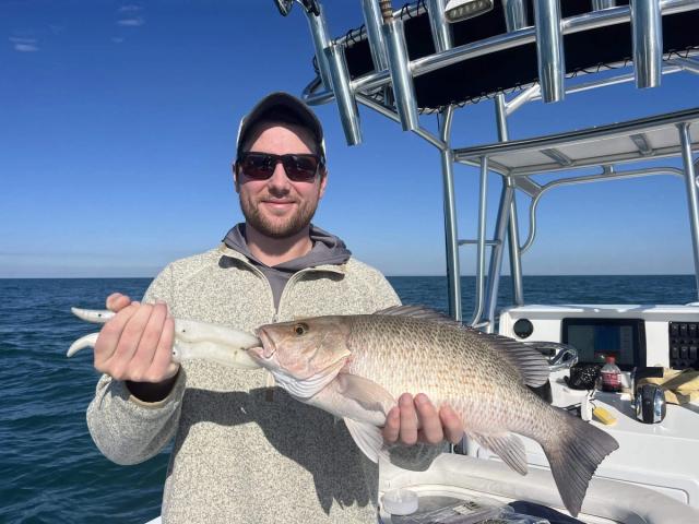 Captain David White Fishing Charters client with their catch