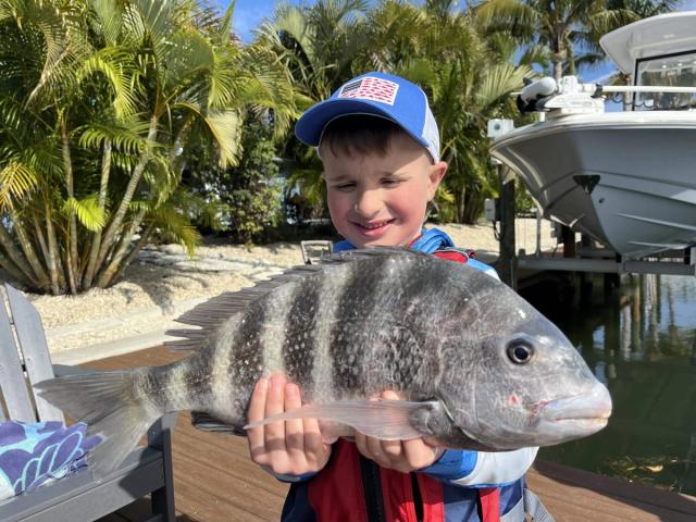 Captain David White Fishing Charters client with their catch