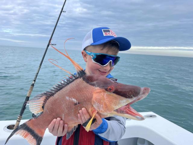 Captain David White Fishing Charters client with their catch