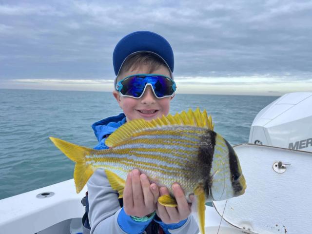 Captain David White Fishing Charters client with their catch