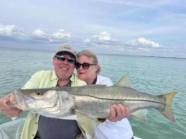 Captain David White Fishing Charters client with their catch