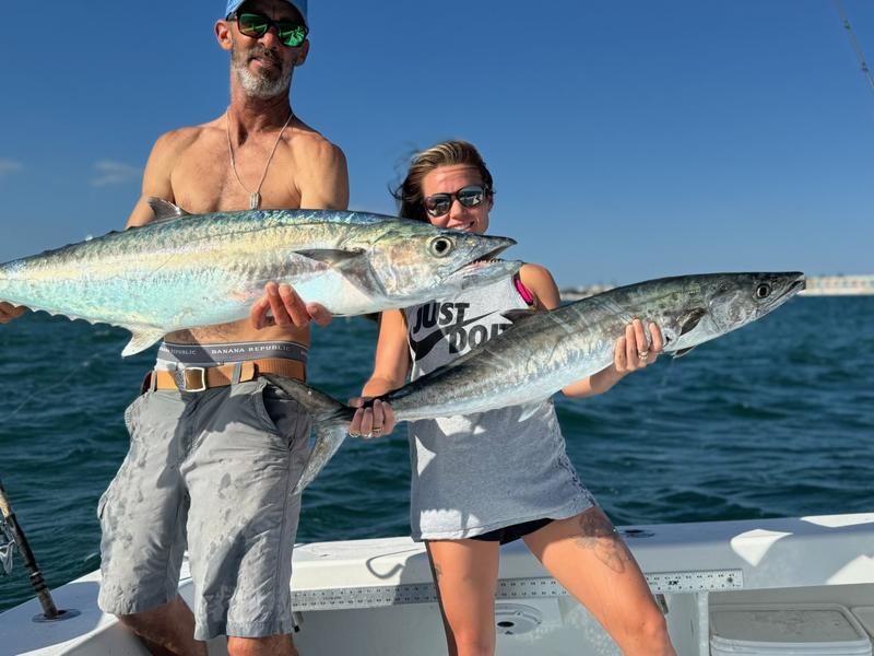 Two anglers holding a pair of king mackerel caught on nearshore structure off Anna Maria Island