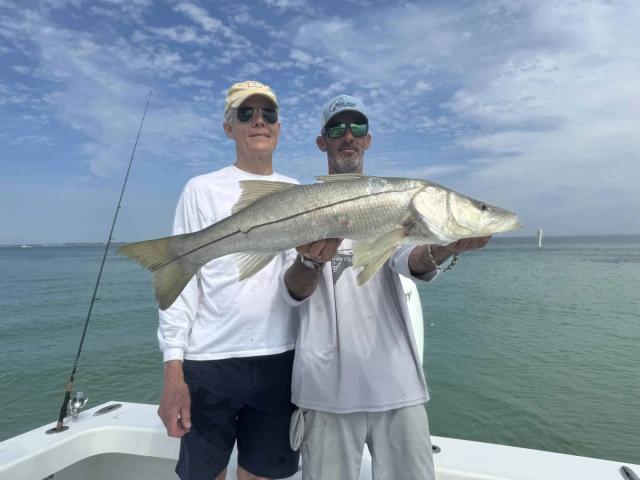 Captain David White Fishing Charters client with their catch