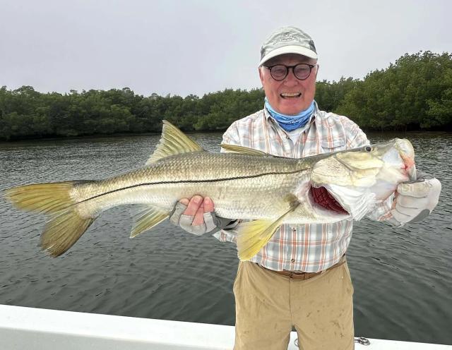 Captain David White Fishing Charters client with their catch