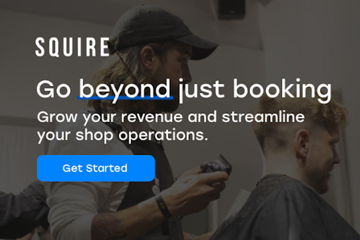 Barber cutting client's hair in a salon.