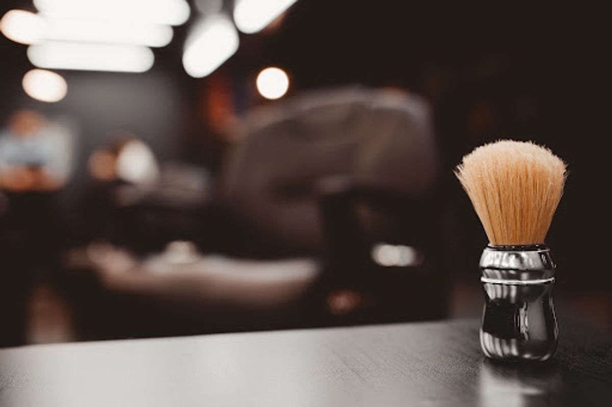 Shaving brush on a barbershop counter.