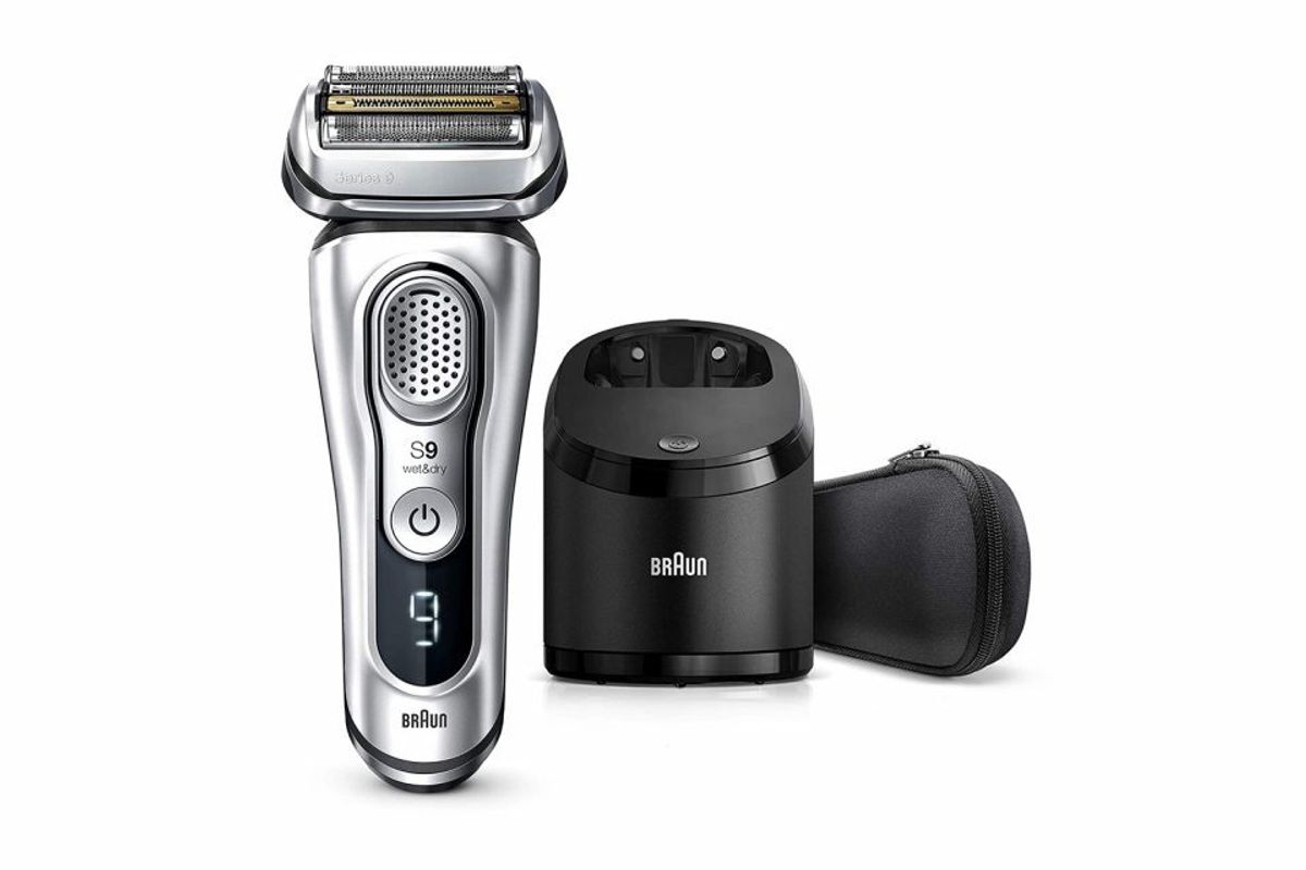 Electric hair clipper set with charging station and travel case.