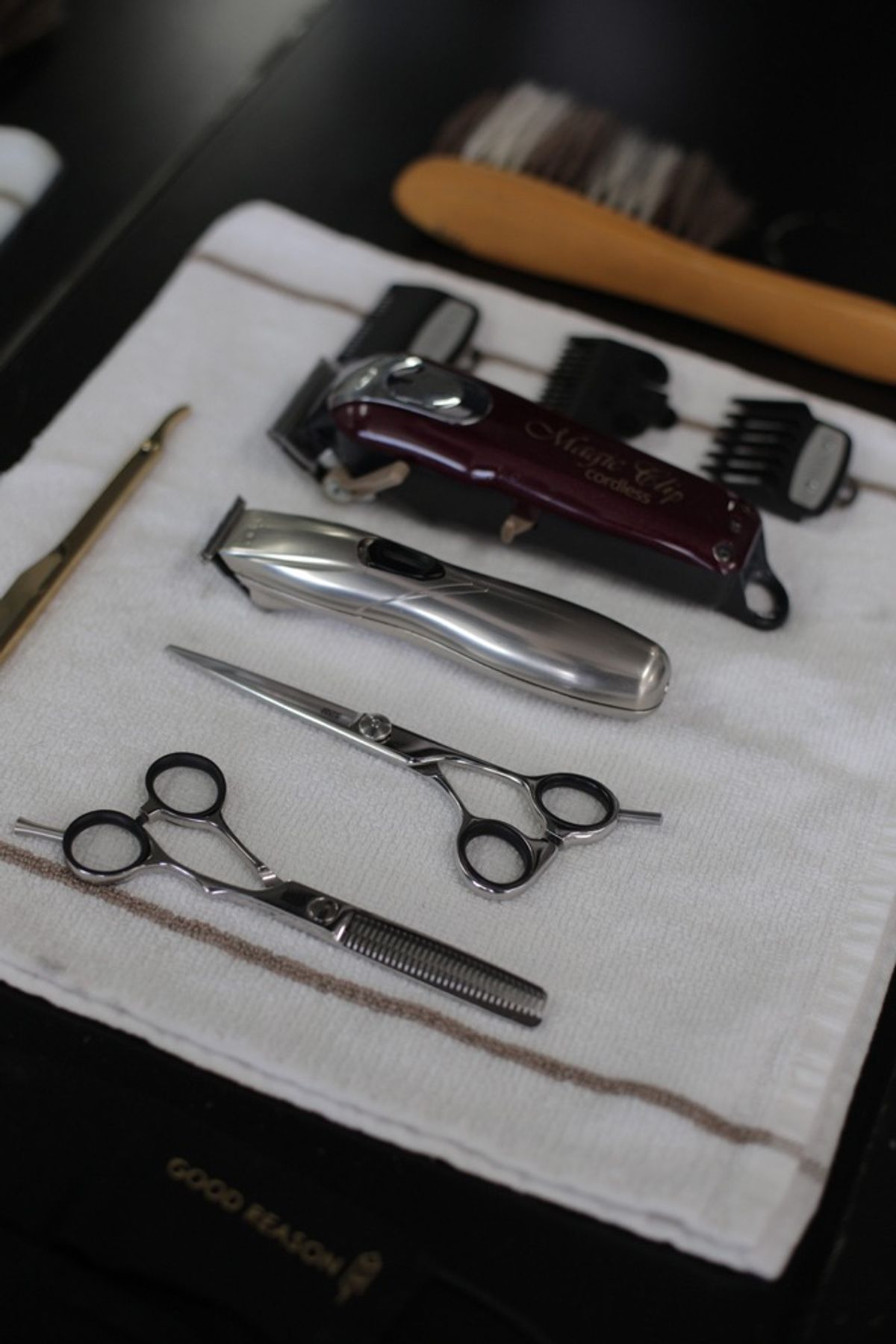 Barber tools including clippers, scissors, and trimmers.