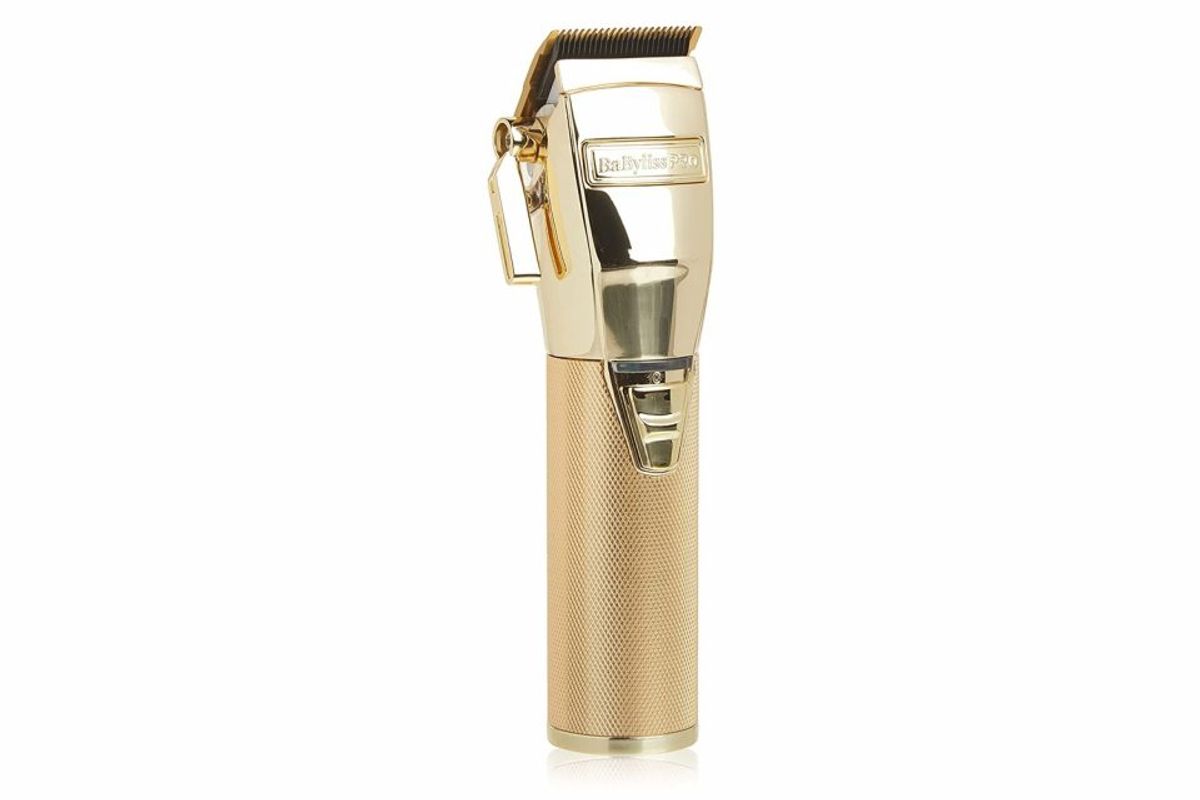 Gold cordless hair clippers with sleek design.