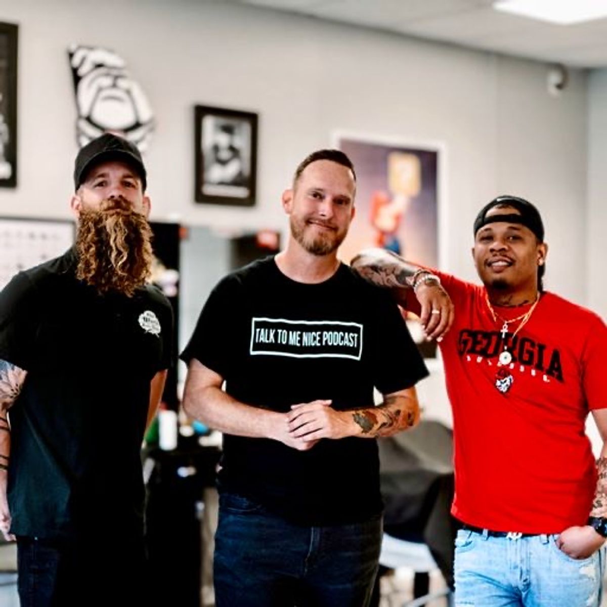 Three men standing inside a barbershop.