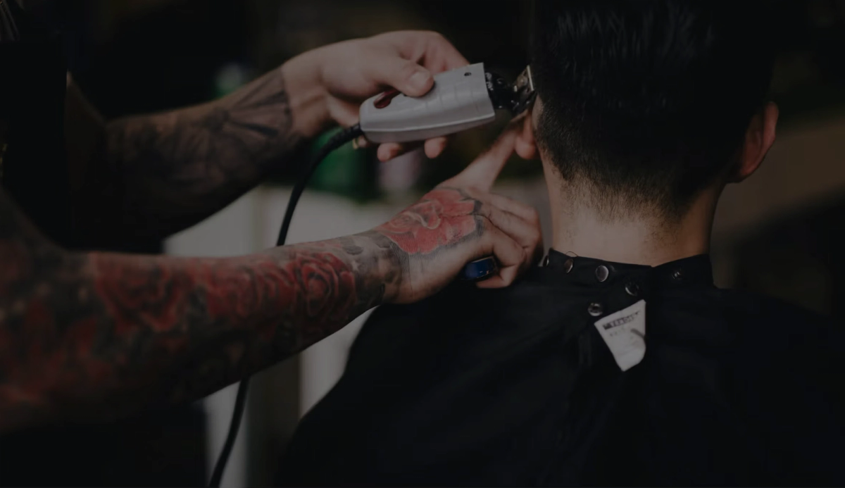Barber performing a haircut for a client inside a barbershop