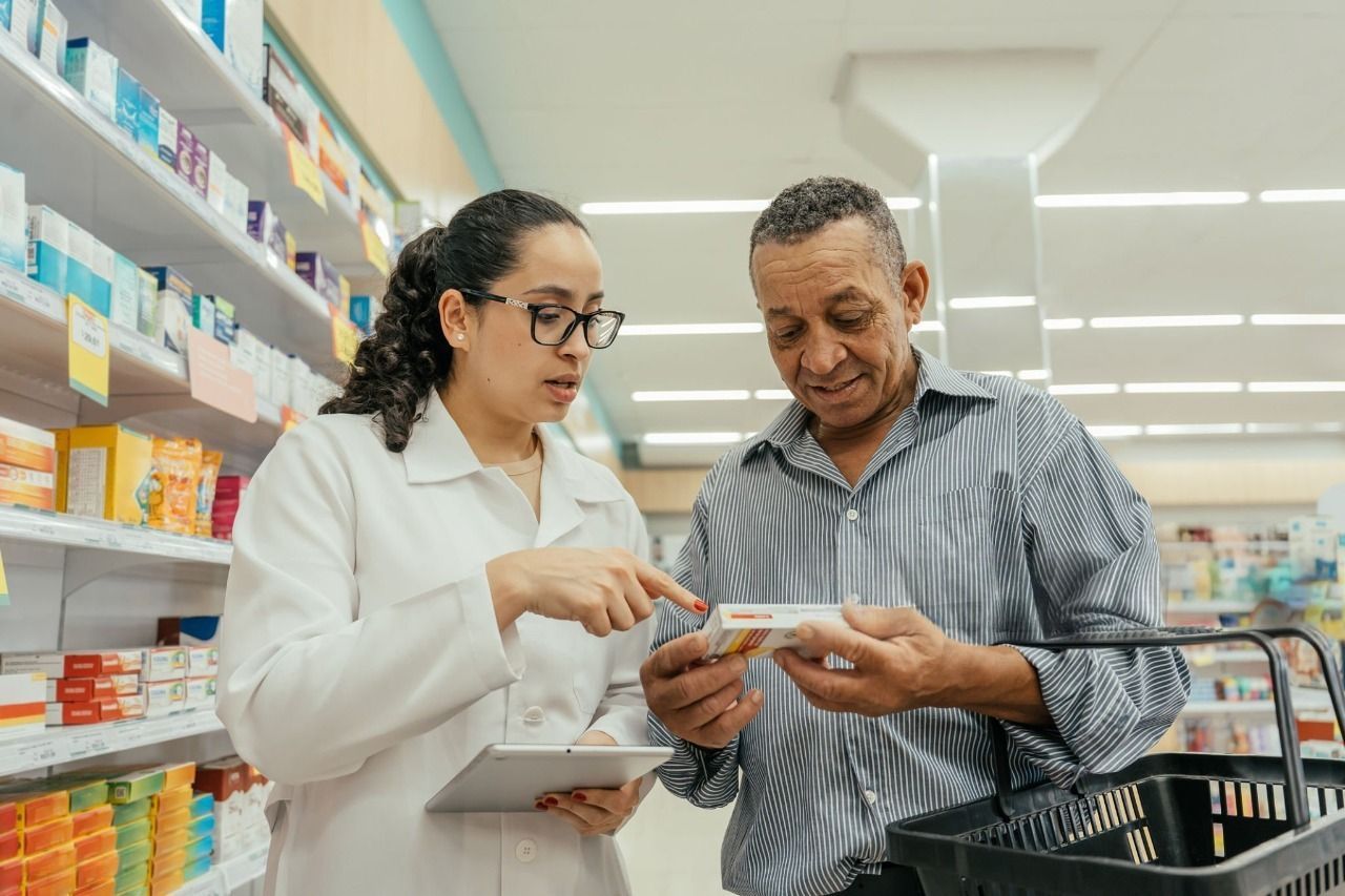 A pharmacist advising a patient in Central Pharmacy