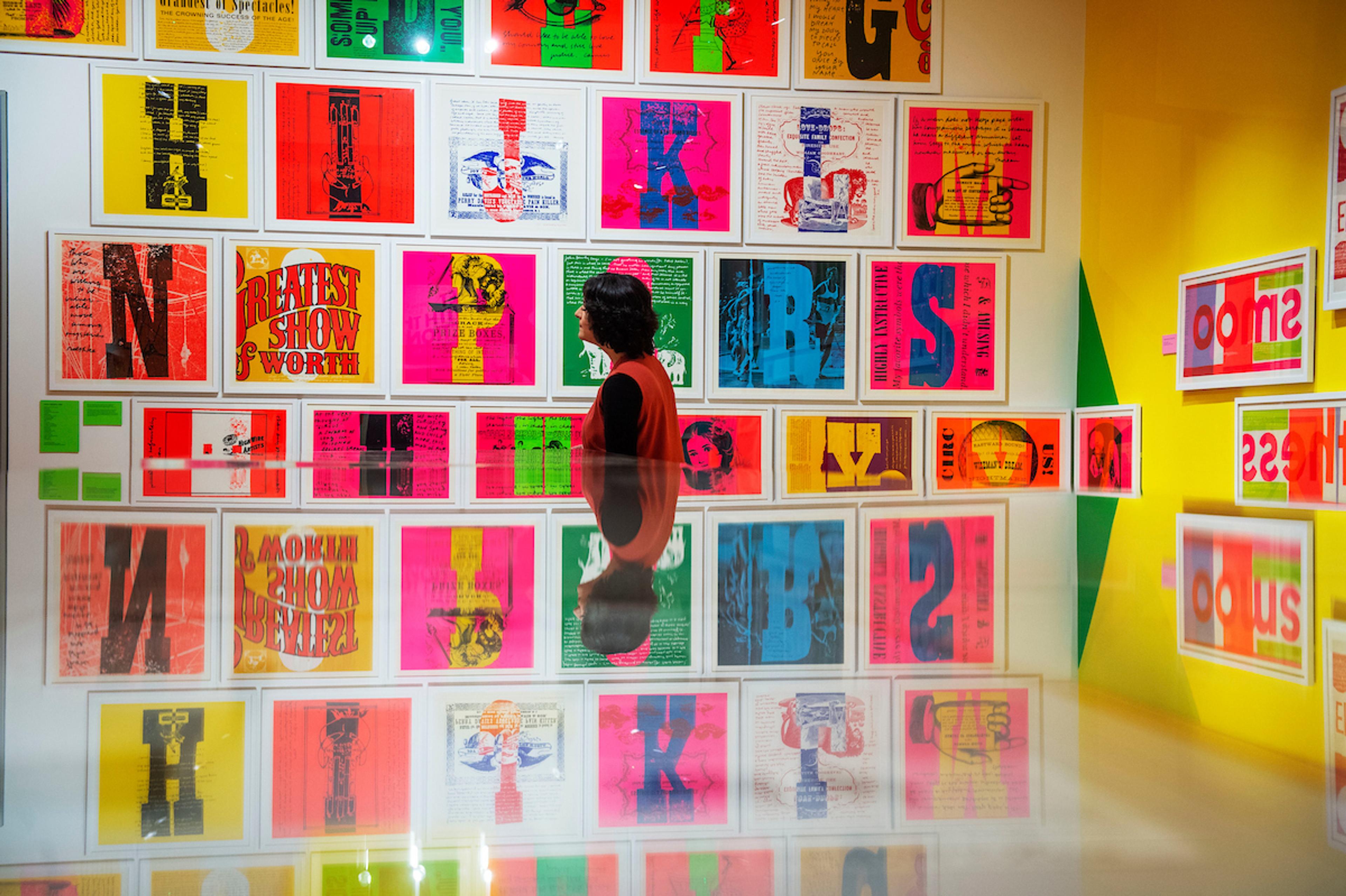 Person looking at brightly coloured framed alphabet prints