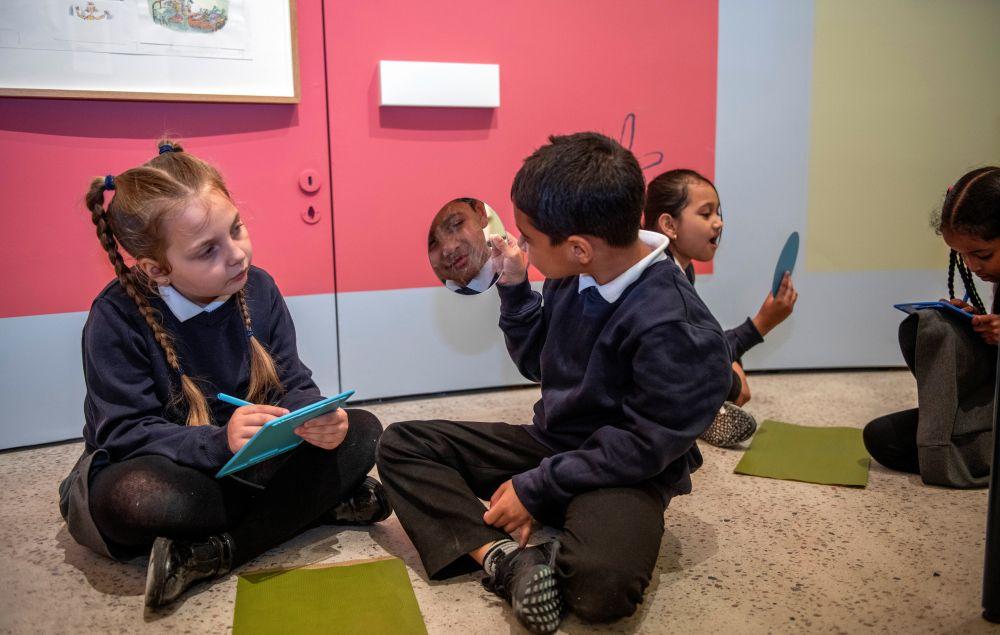 Two schoolchildren sit