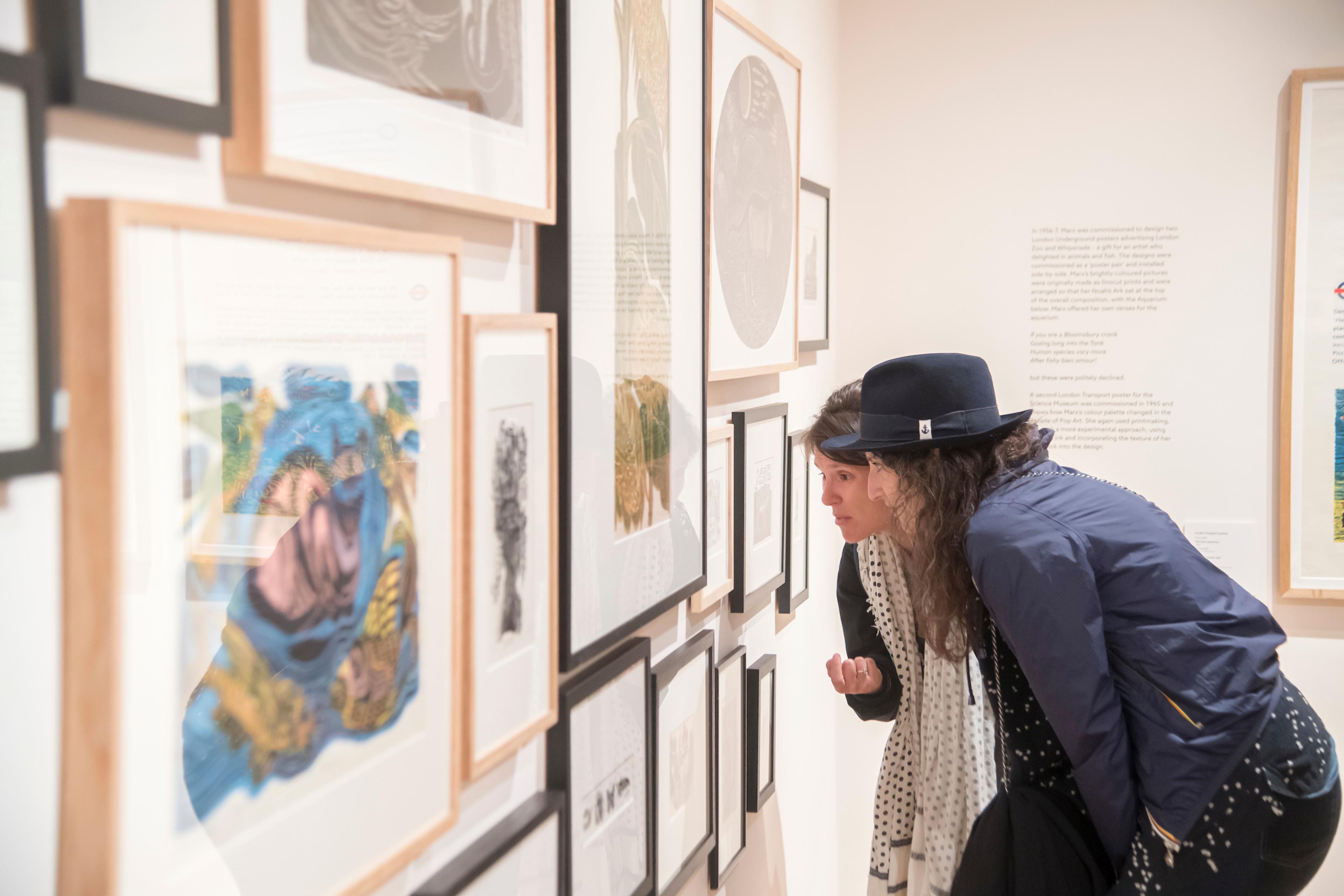 Visitors looking at artwork in the exhibition