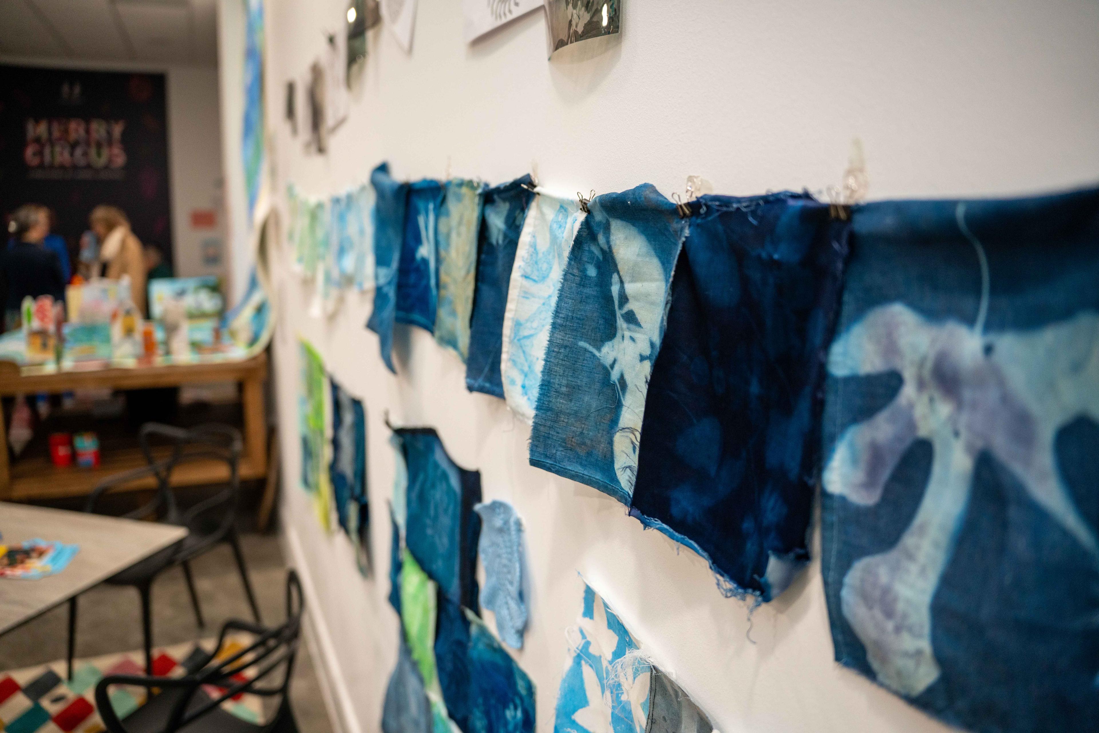 Photograph of a fabric banner hanging on a wall.