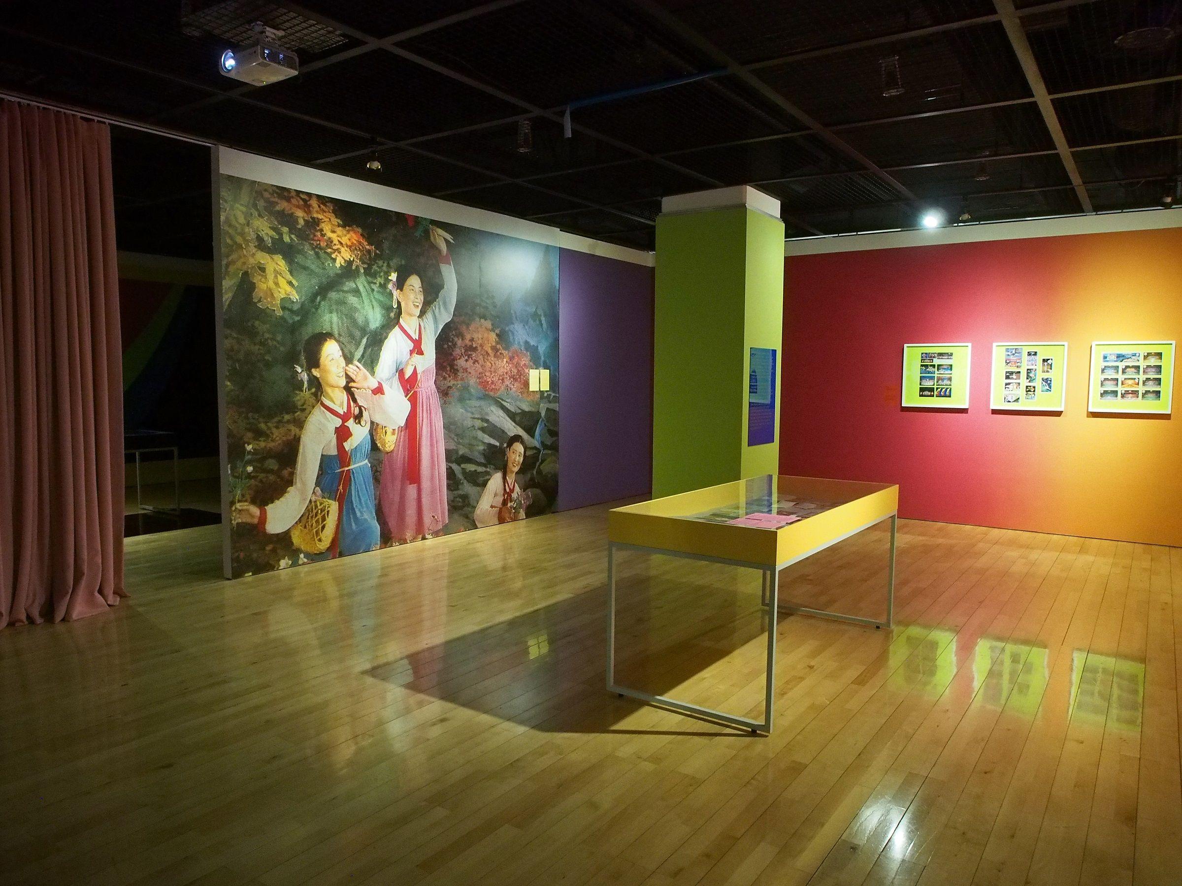 Exhibition gallery with large graphic of a line of dancers