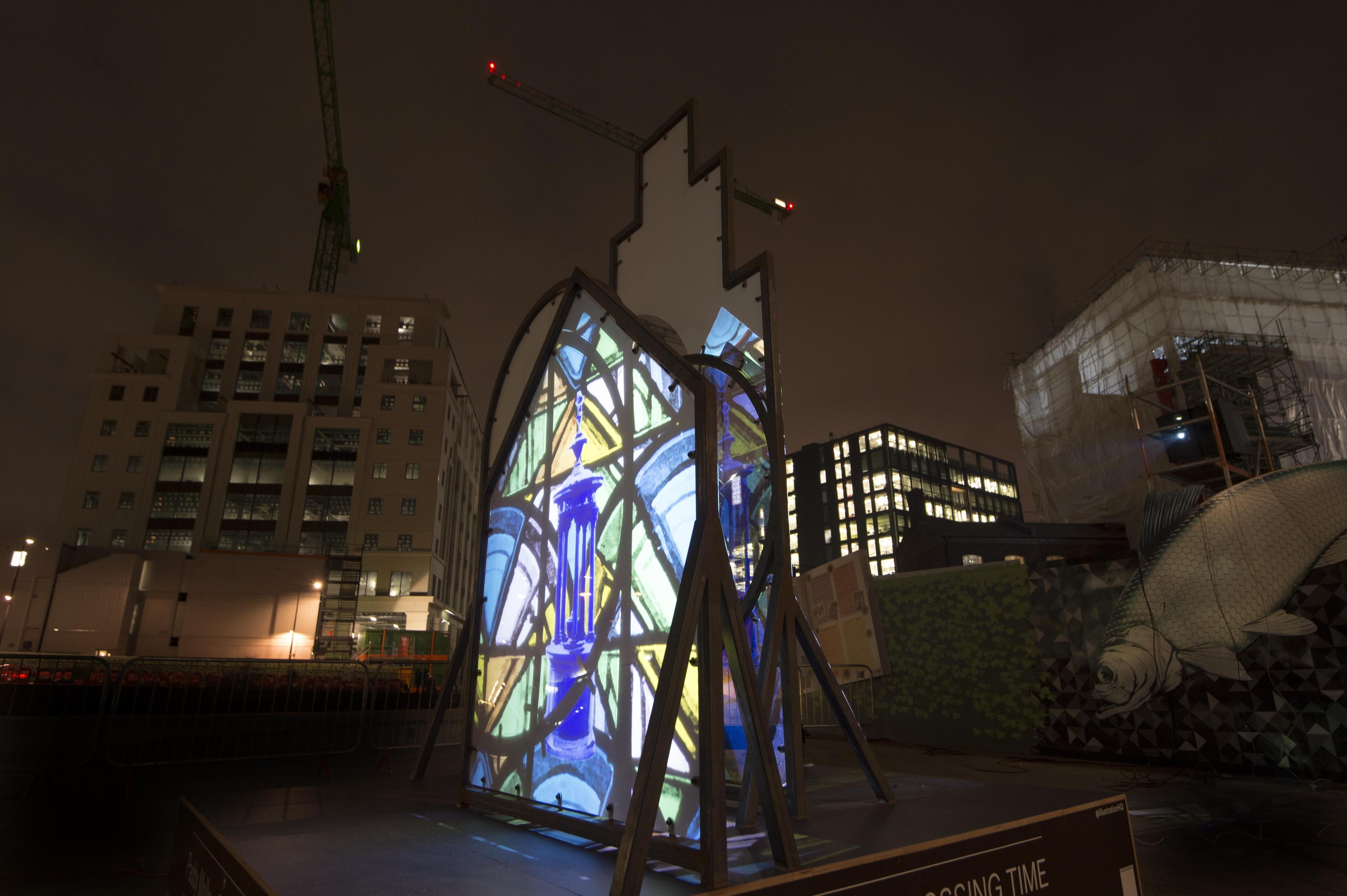 Art installation. Shapes installed outside with illustrations projected onto the shapes.