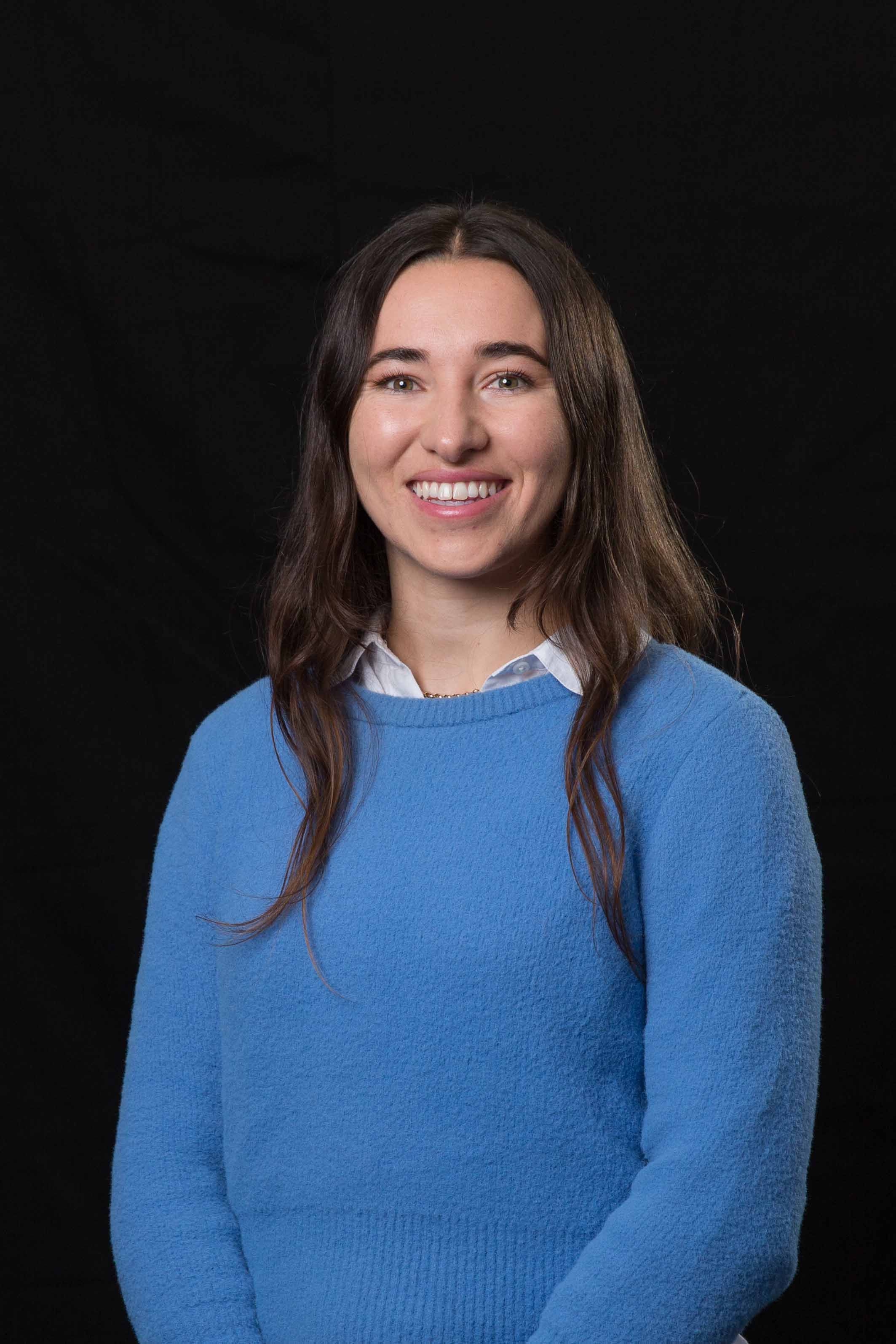 A photograph of a woman in front of a black background 