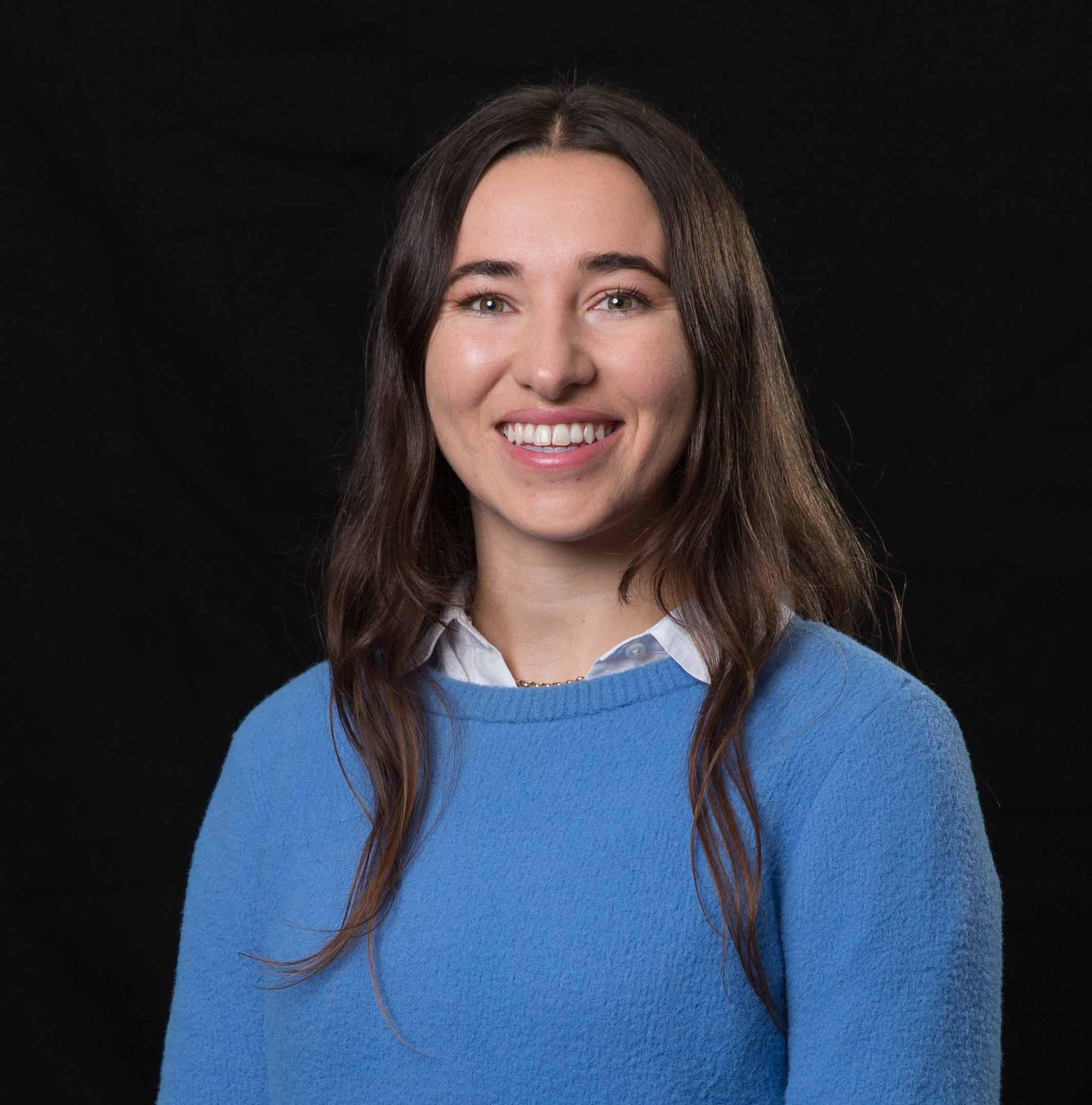 A photograph of a woman in front of a black background