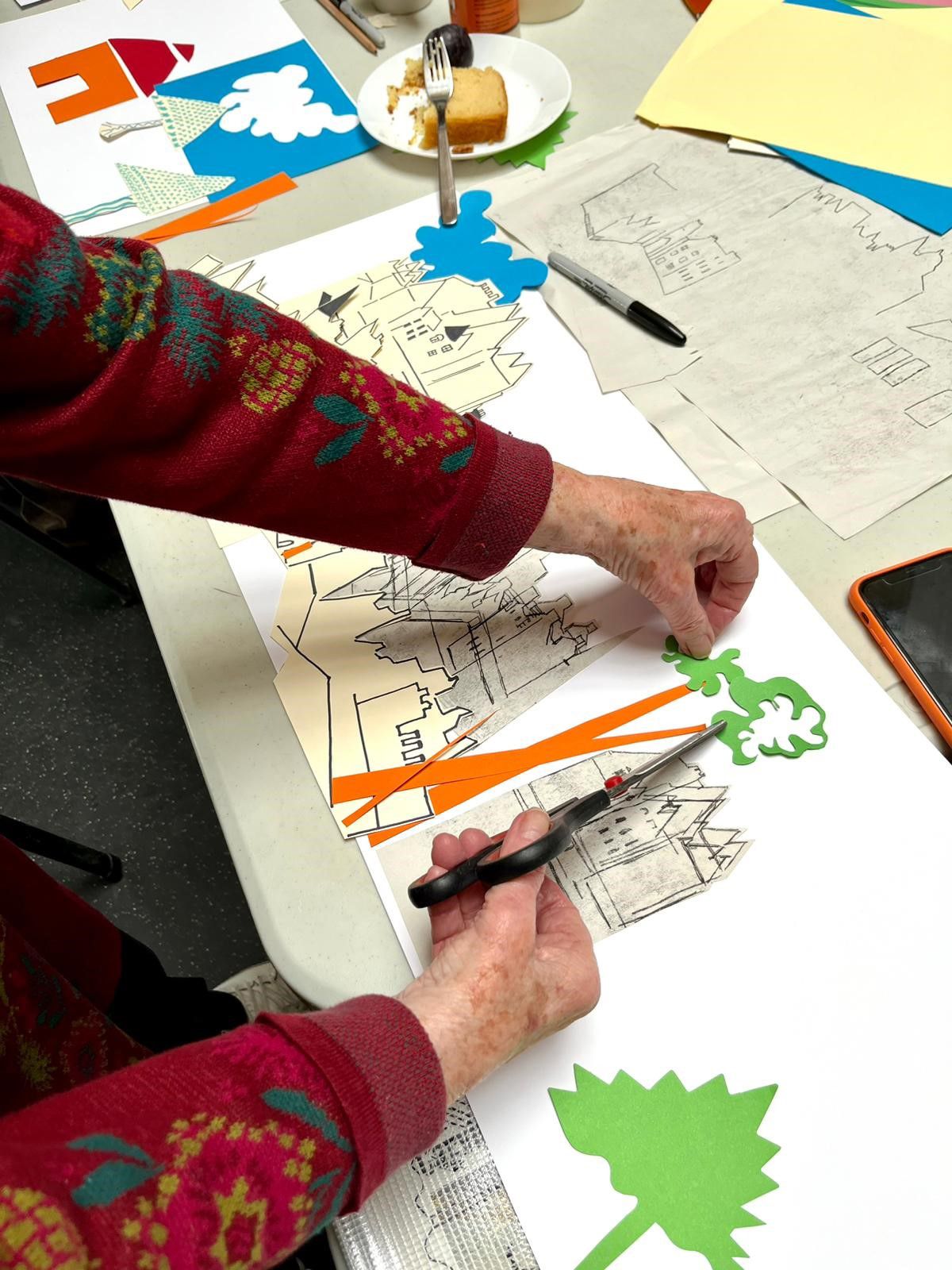 Pair of hands making a collage.