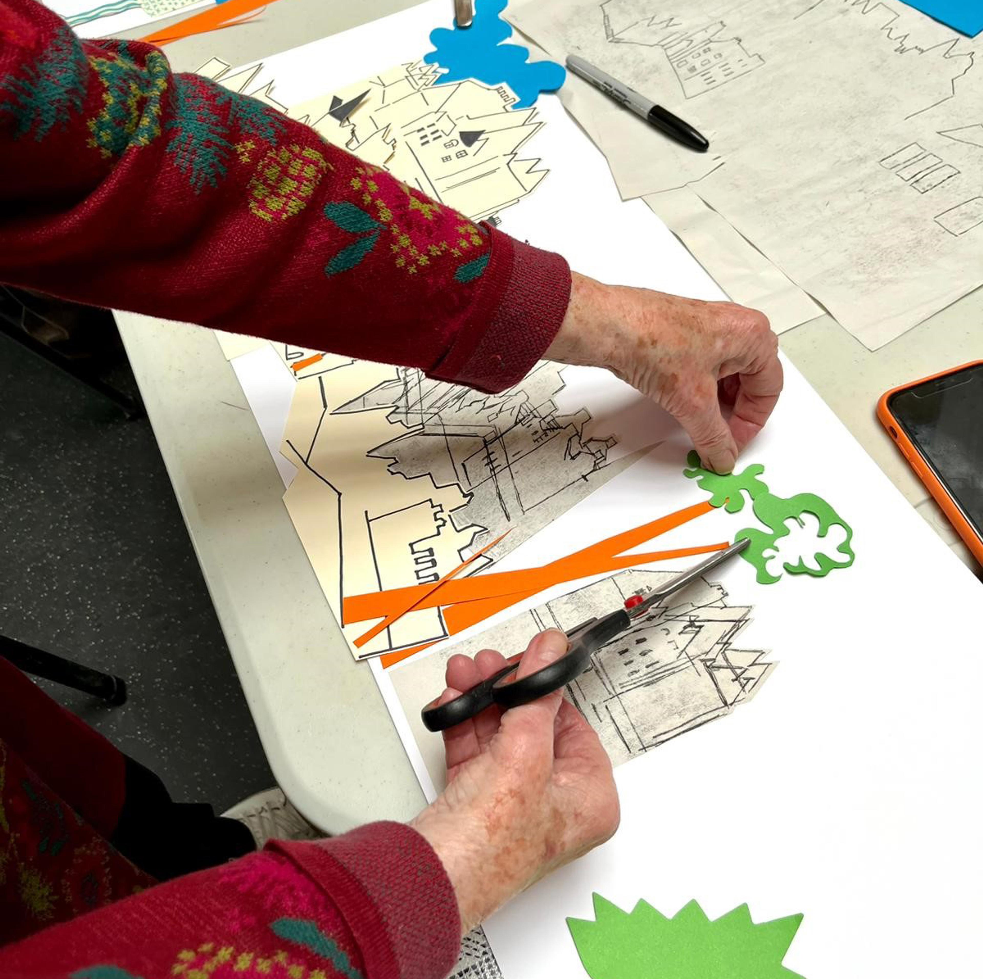 Pair of hands making a collage.