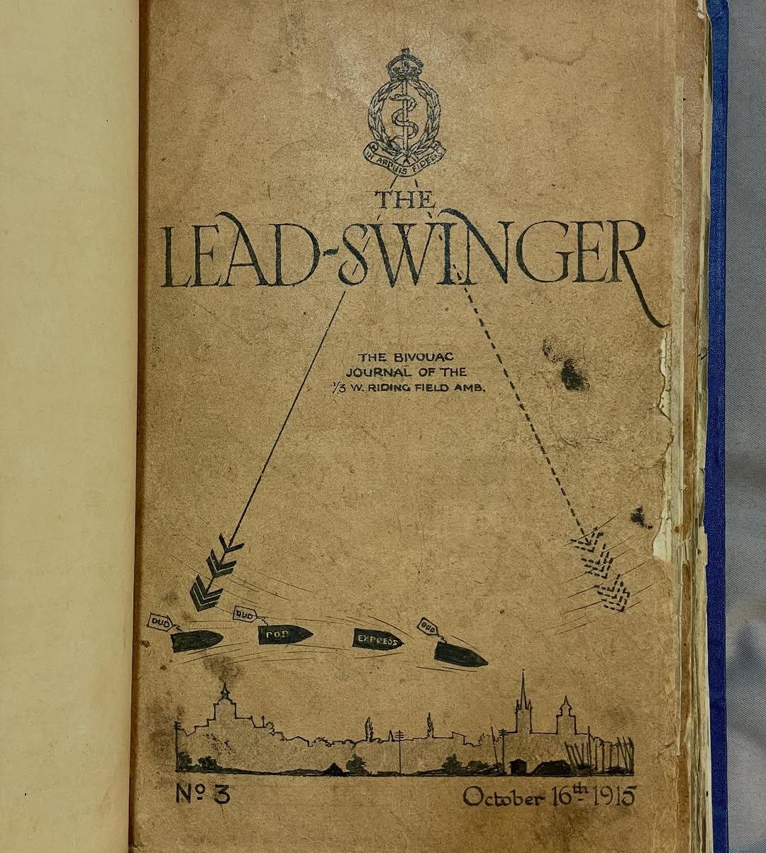 Vintage journal cover titled "The Lead-Swinger," dated October 16th, 1915, featuring military insignia, arrows, and a silhouette of a cityscape.