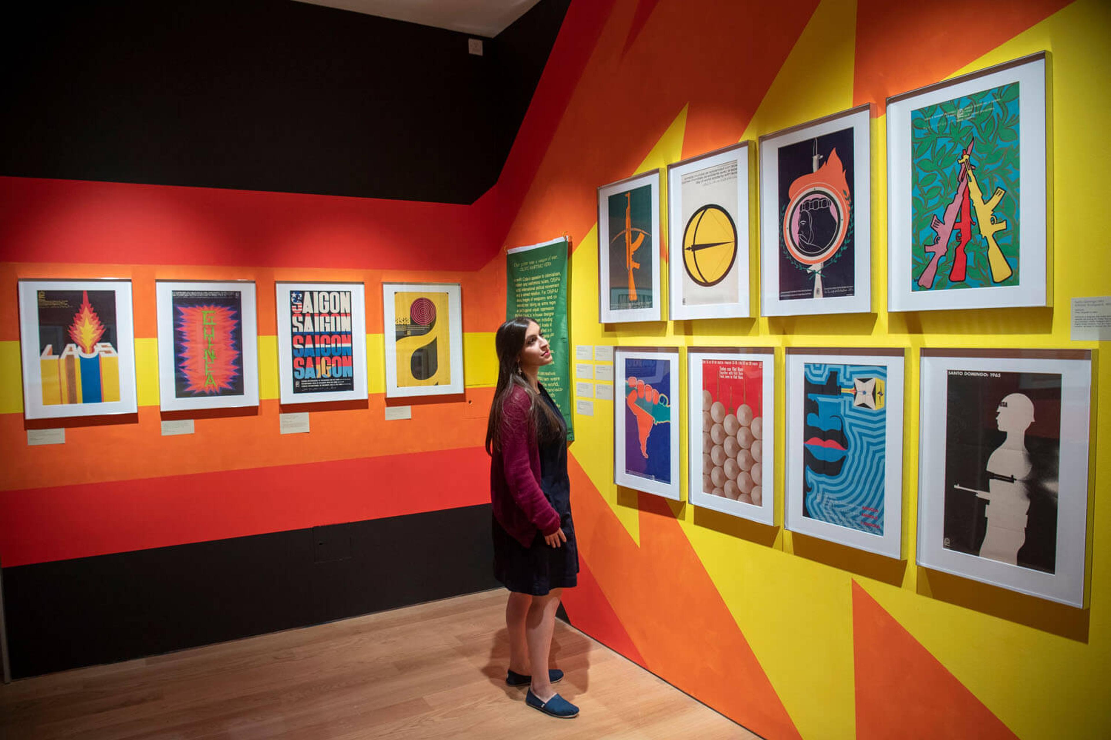 A visitor looking at the posters on display at the exhibition