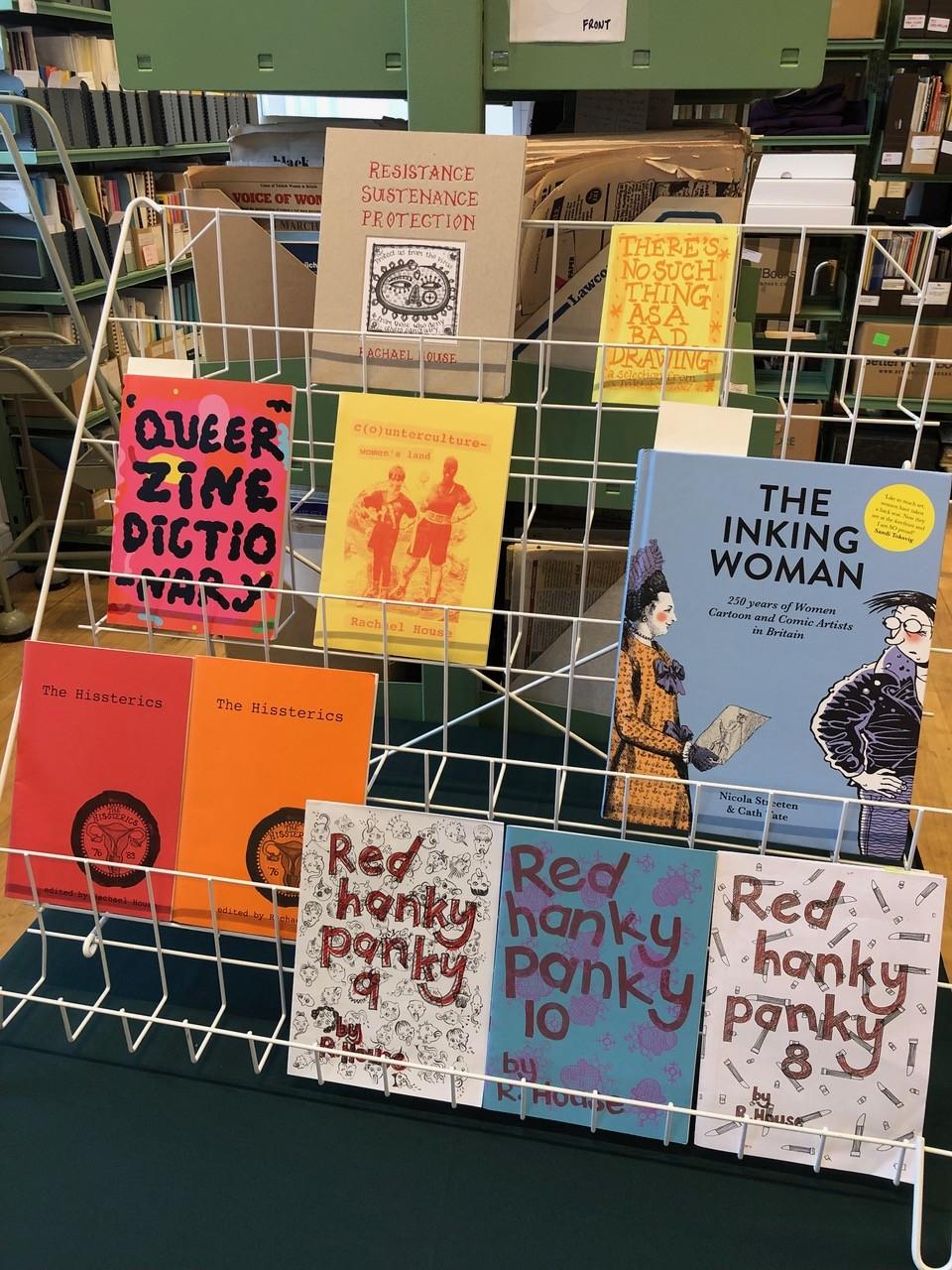 A rack filled with colourful books and zines.