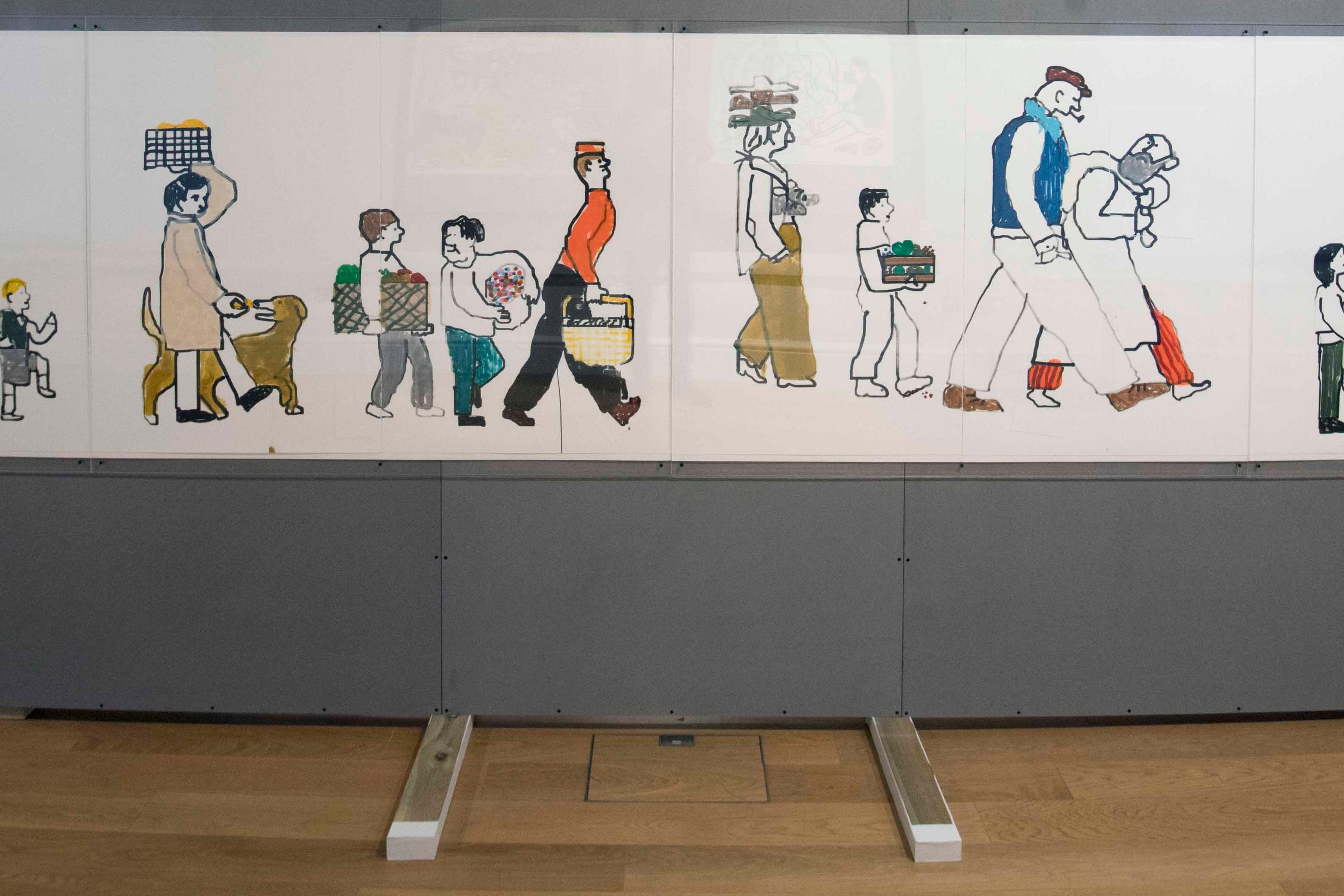 A large wall in an exhibition space with a large illustration of many people on it.