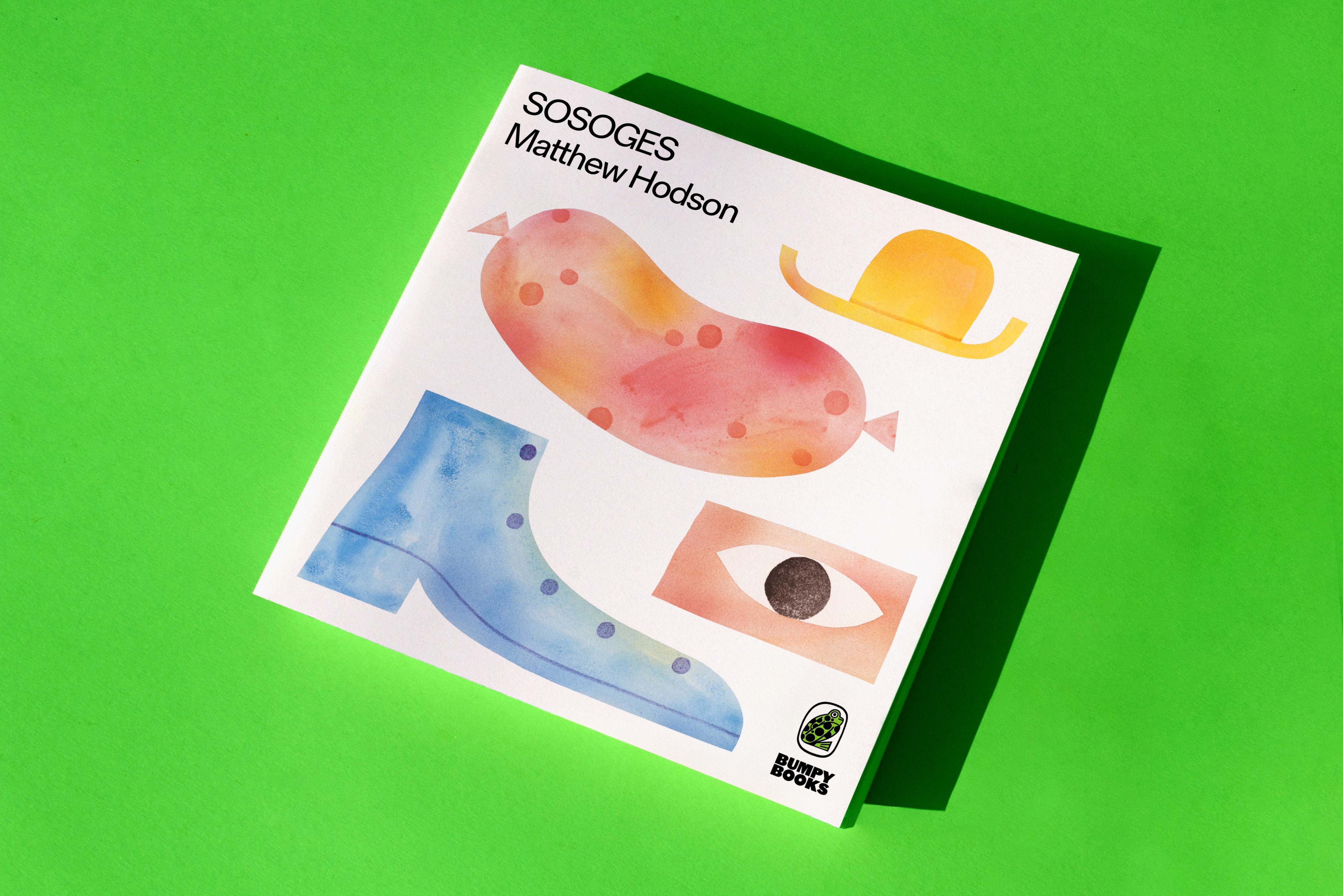 A copy of a book on a green background.