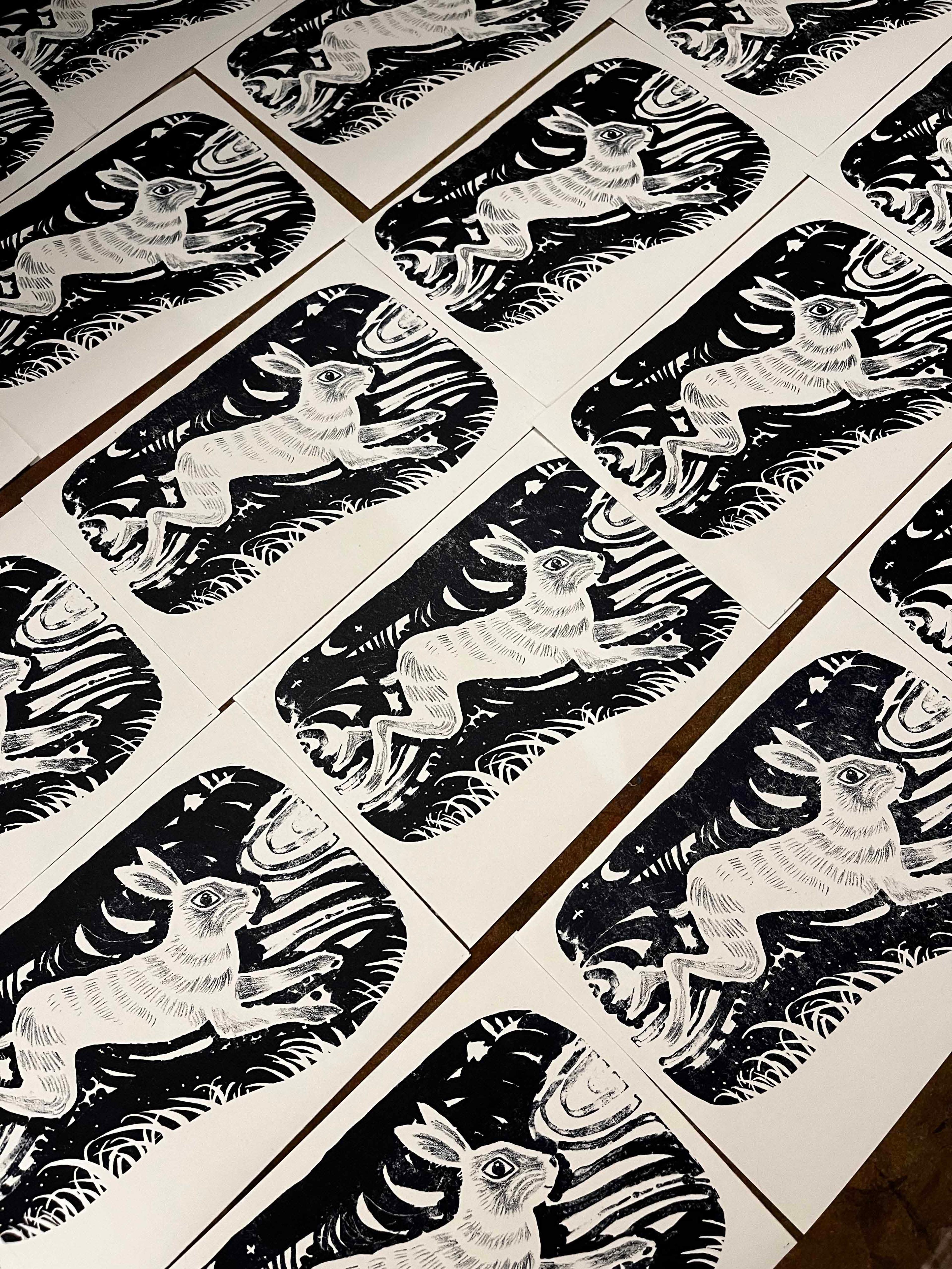 Multiples of lithography prints of a rabbit in black and white.