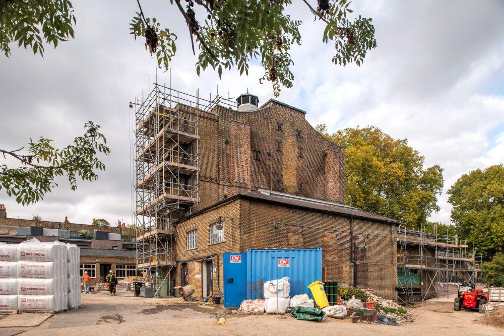 Photo of a three story building covered in scaffolding