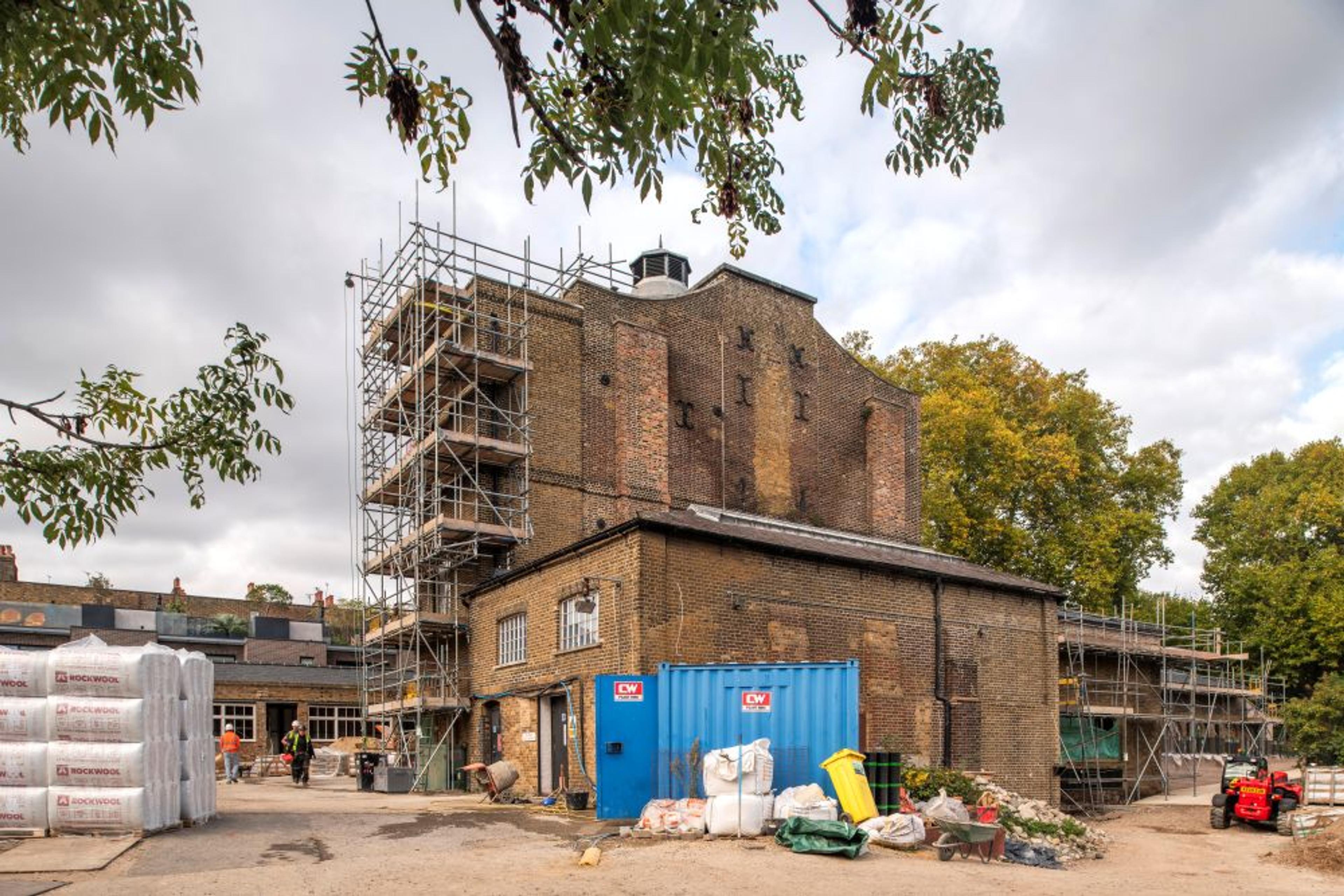 Photo of a three story building covered in scaffolding