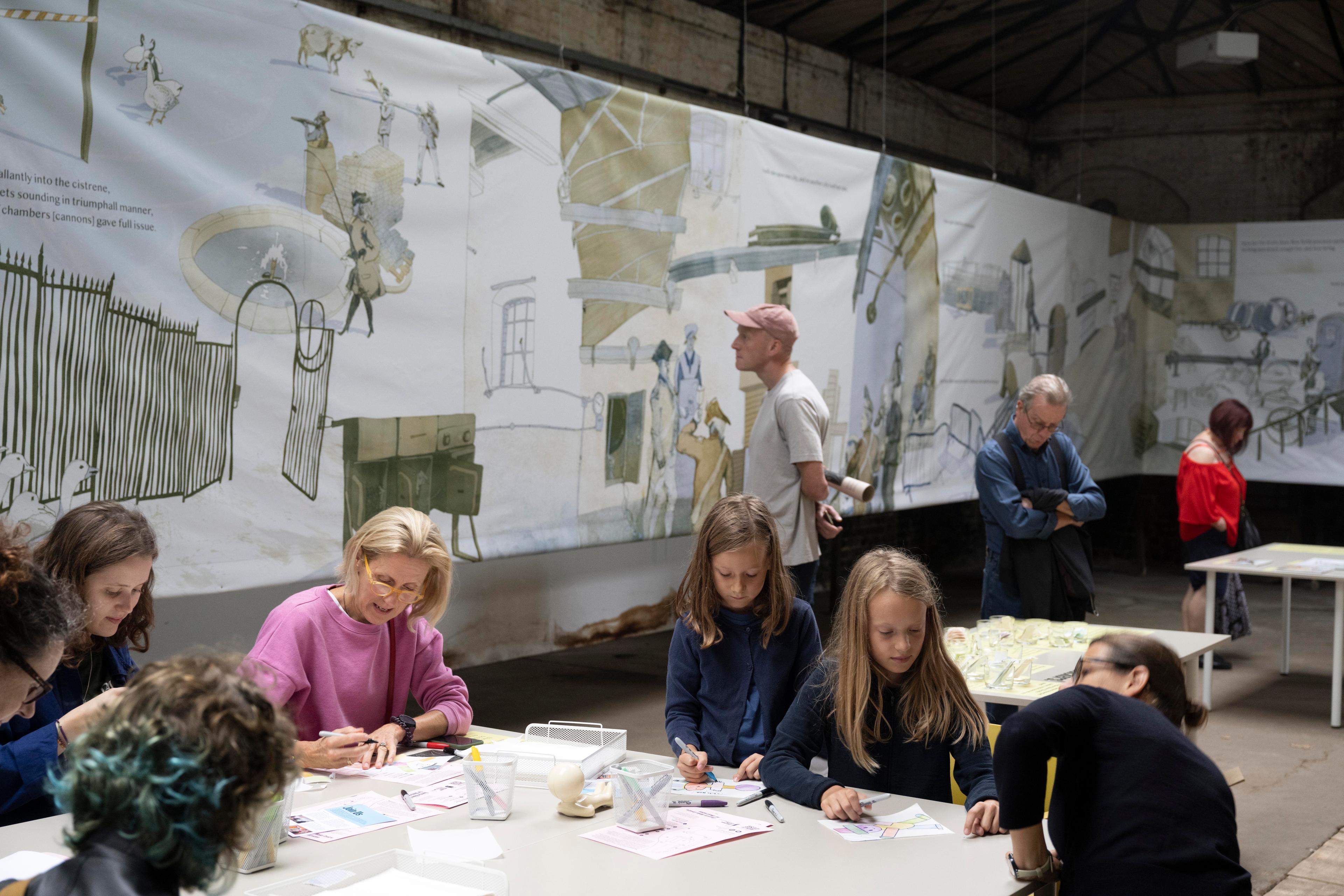 People completing an arts activity at a table.