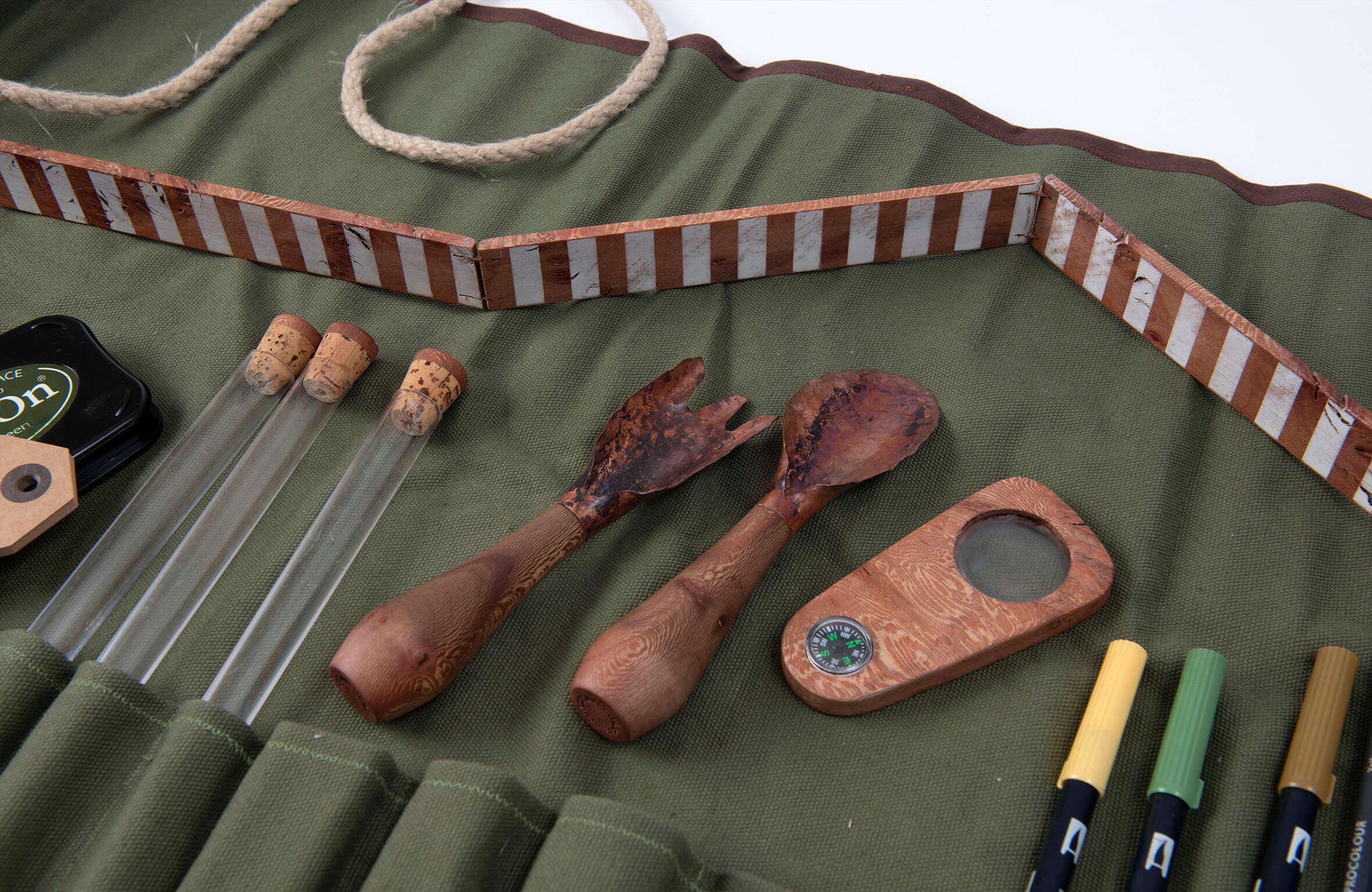 Photograph of a set of tools in a green fabric roll