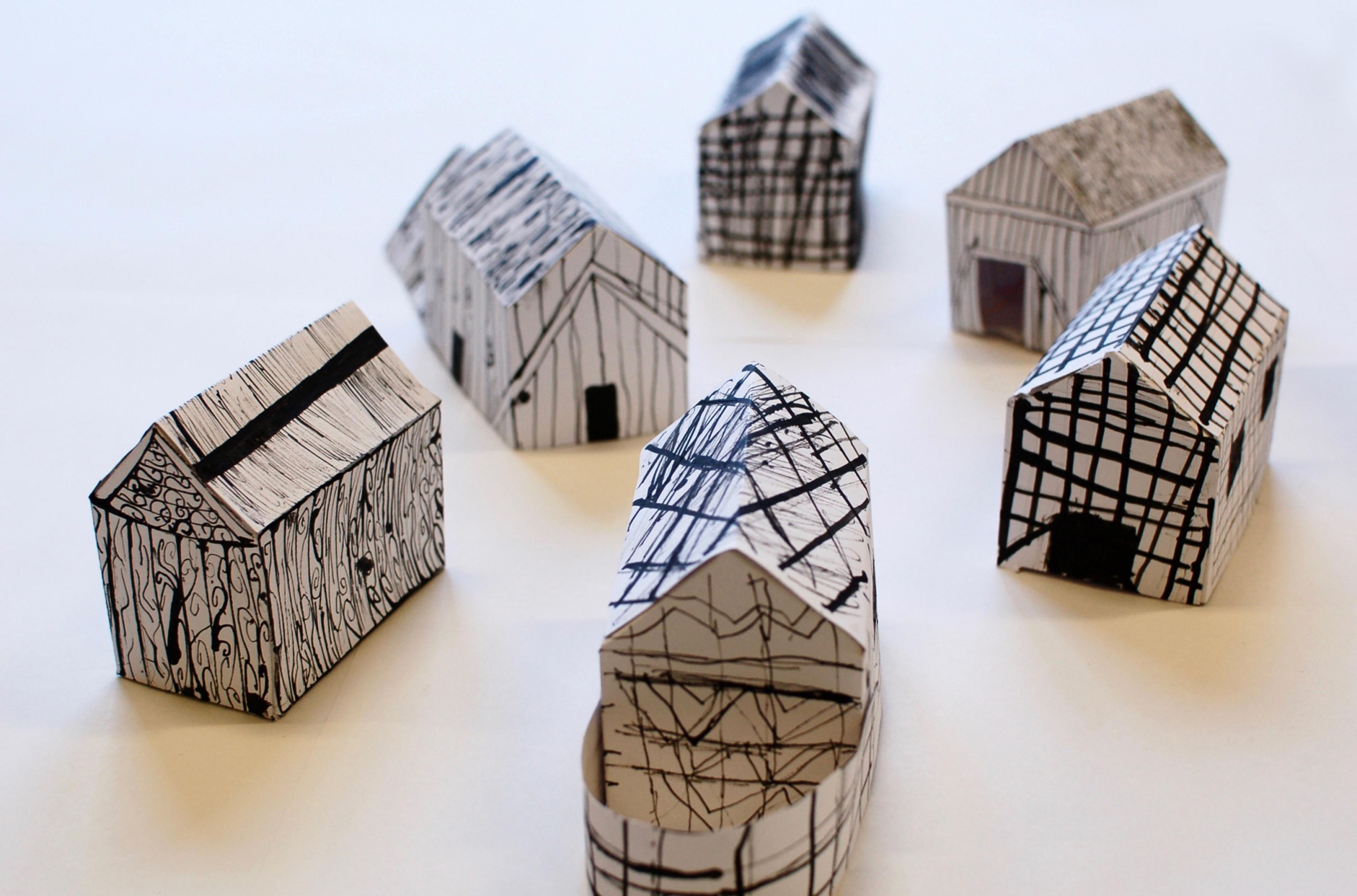 Photograph of 3D paper houses with ink patterns drawn on them