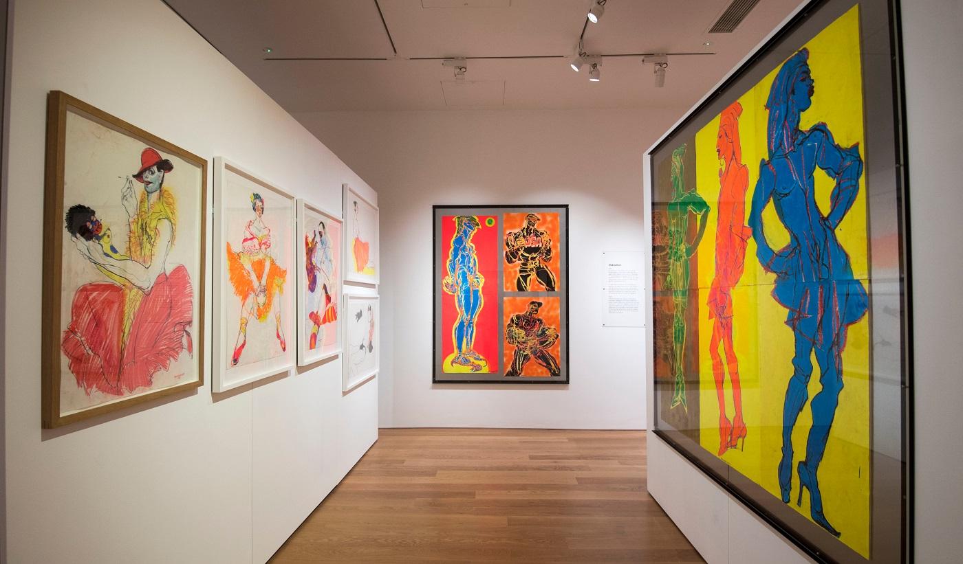 Photograph of large drawings hung on silver sheet metal on white gallery walls