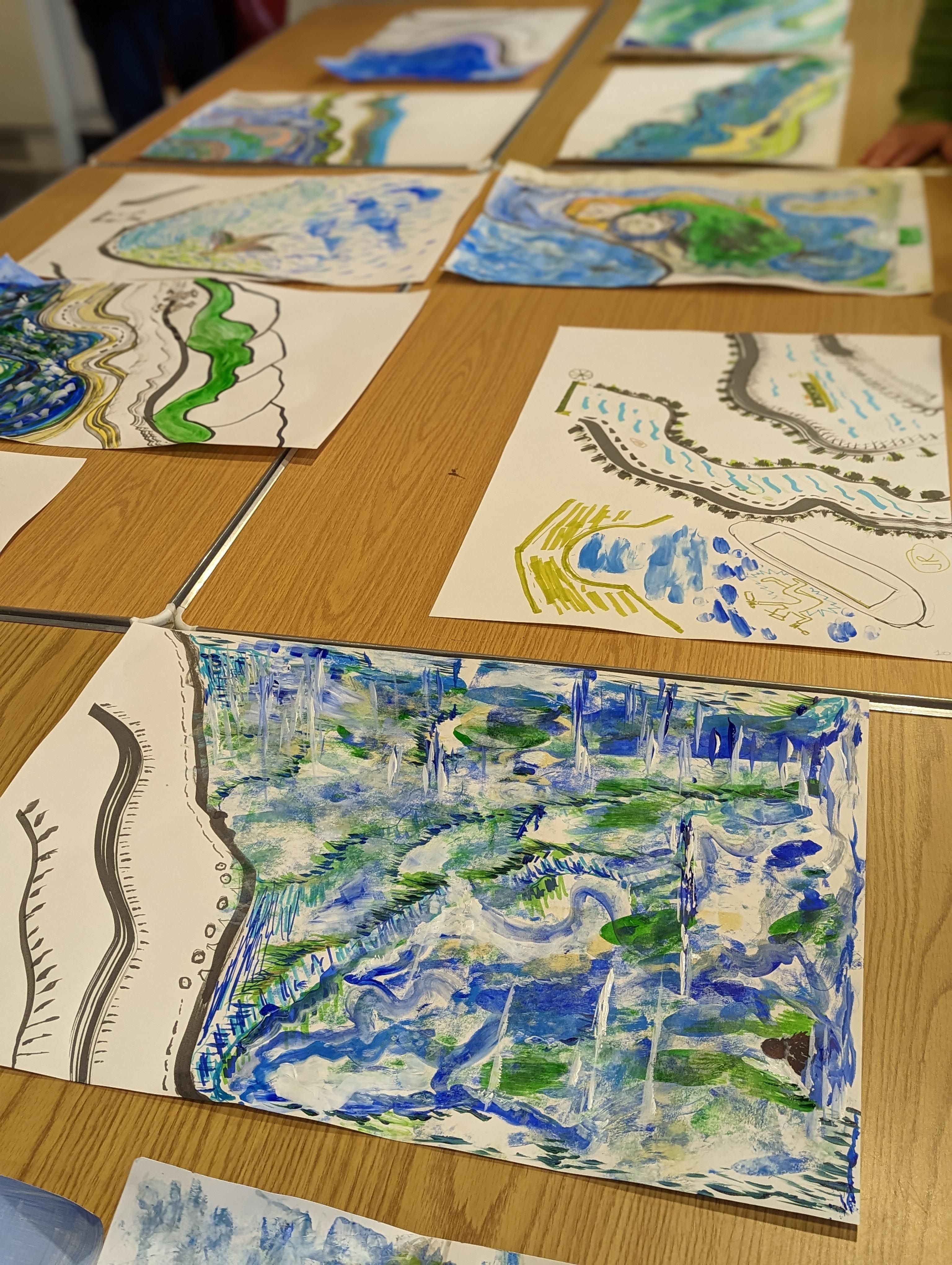 Sheets of illustrated paper on a table.